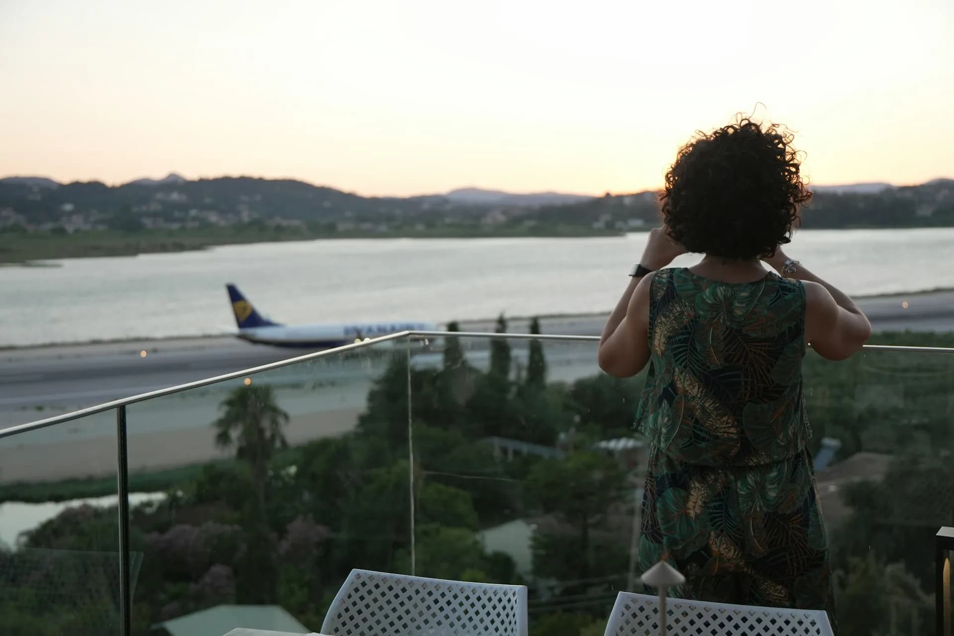 A traveller watching a plane take off from the airport